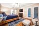 Relaxing main bedroom with hardwood floors, fireplace, and access to the patio at 863 Strathmore Dr, Orlando, FL 32803
