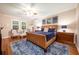 Main bedroom with hardwood floors, a ceiling fan, and a luxurious leather bed at 863 Strathmore Dr, Orlando, FL 32803