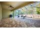 Covered patio with paver stones, a ceiling fan, and screened enclosure at 863 Strathmore Dr, Orlando, FL 32803