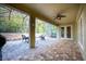 Covered patio with paver stones, a ceiling fan, and screened enclosure at 863 Strathmore Dr, Orlando, FL 32803