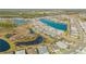 Aerial view of a beautiful community with houses, lakes, and lush greenery at 906 Coral Reef Way, Daytona Beach, FL 32124