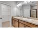 Double vanity bathroom with a large mirror and shower at 906 Coral Reef Way, Daytona Beach, FL 32124