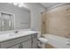 Bathroom with single vanity, tub and tile surround at 906 Coral Reef Way, Daytona Beach, FL 32124