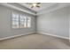 Bright bedroom with carpet flooring and large window at 906 Coral Reef Way, Daytona Beach, FL 32124