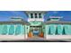 Community clubhouse with teal exterior, inviting entrance, and orange chairs at 906 Coral Reef Way, Daytona Beach, FL 32124