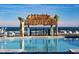 Resort-style pool with beach access, tiki hut, and surfboard accents at 906 Coral Reef Way, Daytona Beach, FL 32124