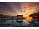 Tranquil pool scene reflecting a vibrant sunset over the ocean at 906 Coral Reef Way, Daytona Beach, FL 32124