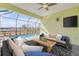 Relaxing poolside patio with seating and screened enclosure at 906 Coral Reef Way, Daytona Beach, FL 32124