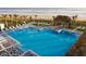 Stunning pool with ocean view, surrounded by lounge chairs and a tiki hut at 906 Coral Reef Way, Daytona Beach, FL 32124