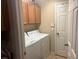 Bright laundry room with washer, dryer, and cabinets at 2776 Spicebush Loop, Apopka, FL 32712