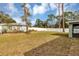 Large backyard with a white vinyl fence and mature trees at 10 Cedar Tree Dr, Ocala, FL 34472