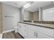 Bathroom with granite countertop, double sinks, and large mirror at 10 Cedar Tree Dr, Ocala, FL 34472