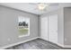 Bedroom with grey walls, wood-look floors, and double doors at 10 Cedar Tree Dr, Ocala, FL 34472