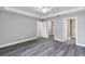 Primary bedroom with wood-look floors and access to bathroom and closet at 10 Cedar Tree Dr, Ocala, FL 34472