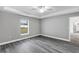 Bedroom with grey walls, wood-look floors, and access to another room at 10 Cedar Tree Dr, Ocala, FL 34472