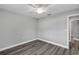 Spacious bedroom with wood-look floors and ceiling fan at 10 Cedar Tree Dr, Ocala, FL 34472