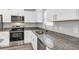 Modern kitchen with white cabinets, granite countertops, and stainless steel appliances at 10 Cedar Tree Dr, Ocala, FL 34472