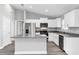 Modern kitchen with white cabinets and a granite island at 10 Cedar Tree Dr, Ocala, FL 34472