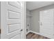 Bright laundry room with white doors and wood-look flooring at 10 Cedar Tree Dr, Ocala, FL 34472