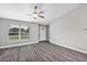 Living room featuring grey flooring, a ceiling fan, and a white door at 10 Cedar Tree Dr, Ocala, FL 34472