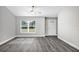 Living room with grey flooring, a ceiling fan, and a white door at 10 Cedar Tree Dr, Ocala, FL 34472