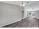 Spacious living room with wood-look floors and a ceiling fan at 10 Cedar Tree Dr, Ocala, FL 34472