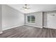 Spacious living room with grey wood-look floors and a ceiling fan at 10 Cedar Tree Dr, Ocala, FL 34472