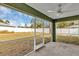 Relaxing screened porch overlooking backyard with ceiling fan at 10 Cedar Tree Dr, Ocala, FL 34472