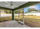 Covered screened porch with ceiling fan and backyard view at 10 Cedar Tree Dr, Ocala, FL 34472