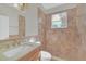 Bathroom with tile shower, vanity, and toilet at 10125 Foxhurst Ct, Orlando, FL 32836
