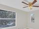 Bright bedroom with large window and ceiling fan at 10125 Foxhurst Ct, Orlando, FL 32836
