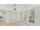 Elegant dining room featuring arched windows and built-in shelving at 10125 Foxhurst Ct, Orlando, FL 32836
