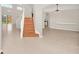 Bright entryway with tiled floors and wooden staircase at 10125 Foxhurst Ct, Orlando, FL 32836