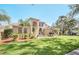 Two-story house with a landscaped lawn and palm trees at 10125 Foxhurst Ct, Orlando, FL 32836