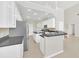 Modern kitchen with white cabinets, stainless steel appliances, and granite countertops at 10125 Foxhurst Ct, Orlando, FL 32836