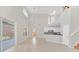 Open floor plan boasts a spacious kitchen with stainless steel appliances and island, adjacent to a Gathering room with fireplace and built-in shelving at 10125 Foxhurst Ct, Orlando, FL 32836