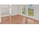 Living room with hardwood floors and large windows at 10125 Foxhurst Ct, Orlando, FL 32836