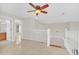 Spacious loft area with hardwood floors and white railings at 10125 Foxhurst Ct, Orlando, FL 32836