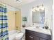 Bathroom with updated vanity and striped shower curtain at 1015 S Hiawassee Rd # 3522, Orlando, FL 32835