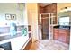 Bathroom featuring a soaking tub, separate glass shower, and granite countertops at 10215 Yonaomi Cir, Clermont, FL 34711