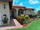 Attractive front entry with landscaping, brick walkway, and arched entryway at 10215 Yonaomi Cir, Clermont, FL 34711