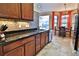 Modern kitchen featuring dark countertops, mosaic backsplash, stainless steel appliances, and a cozy breakfast nook at 10215 Yonaomi Cir, Clermont, FL 34711