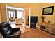 Sitting room with natural light from the adjacent sunroom and comfortable leather recliner at 10215 Yonaomi Cir, Clermont, FL 34711