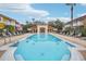 Relaxing community pool with lounge chairs at 1023 Lake Berkley Dr, Kissimmee, FL 34746