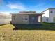 Home exterior showcasing a screened patio and grassy yard at 1162 Atlantic Ave, Fruitland Park, FL 34731