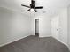 Bright bedroom with grey carpet, ceiling fan and double door closet at 1162 Atlantic Ave, Fruitland Park, FL 34731