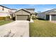 Two-story house with attached garage and landscaped lawn at 1162 Atlantic Ave, Fruitland Park, FL 34731