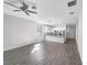 Open living area with wood-look tile floors and kitchen island at 1162 Atlantic Ave, Fruitland Park, FL 34731
