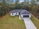 One-story house with driveway and grassy area at 13566 Sw 79Th Terrace Rd, Ocala, FL 34473