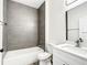 Modern bathroom with gray tile and white vanity at 13566 Sw 79Th Terrace Rd, Ocala, FL 34473